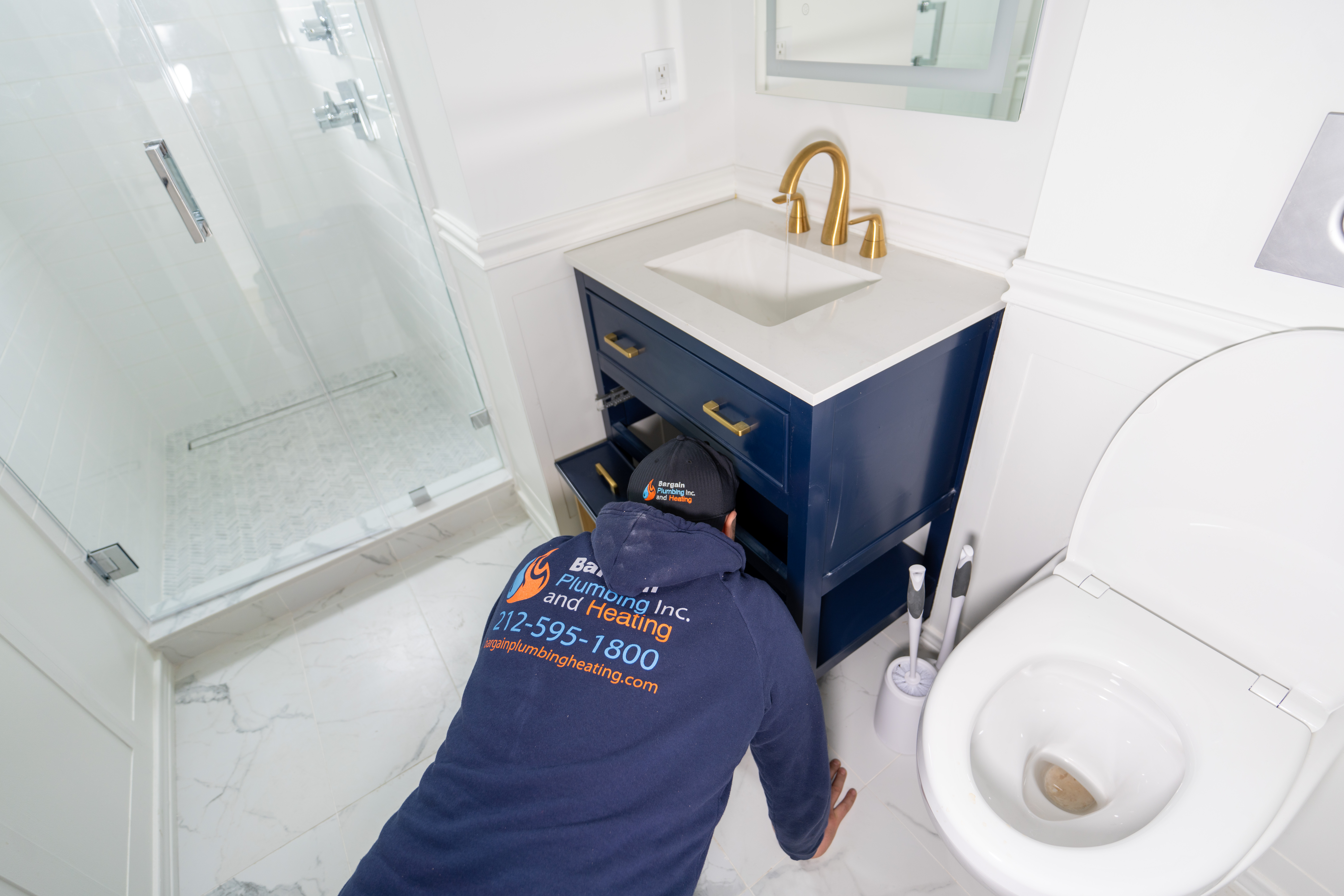 Licensed NYC plumbing company technician fixing a sink